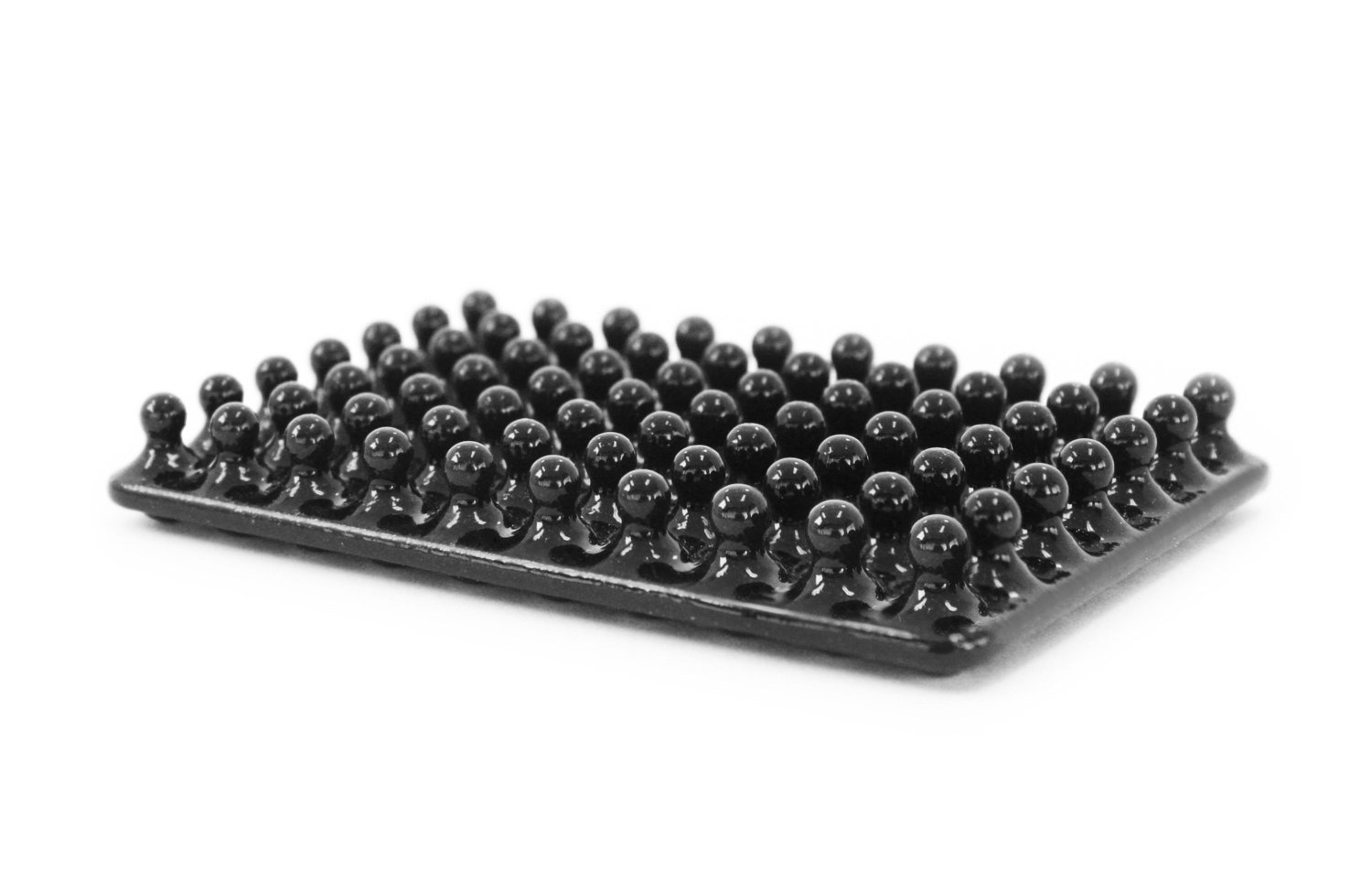 Black ceramic soap dish with lots of little balls in rows